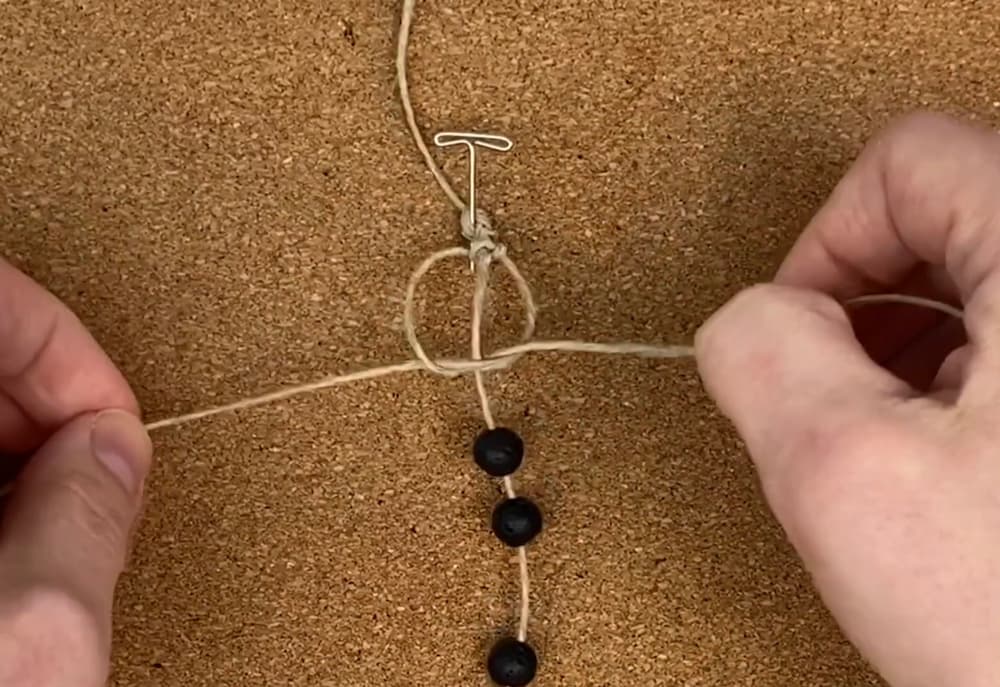 tie a square knot around the center cord with the working cord | macrame hemp bracelet with beads