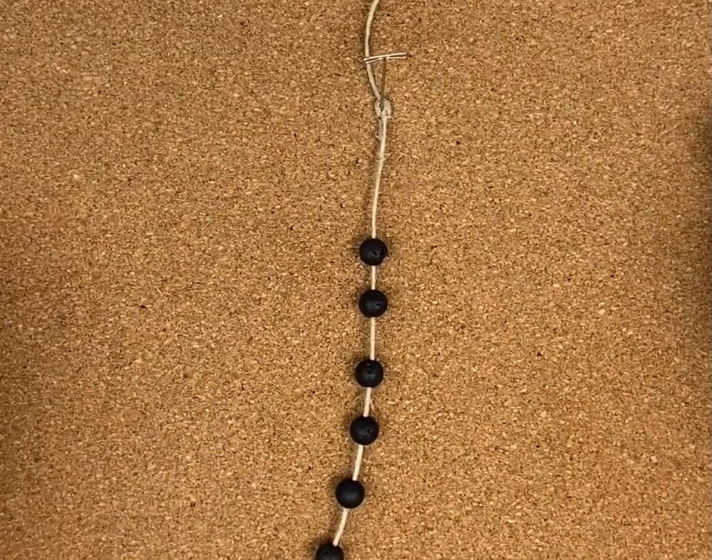 secure the macrame hemp bracelet center cord to your cork board or work surface