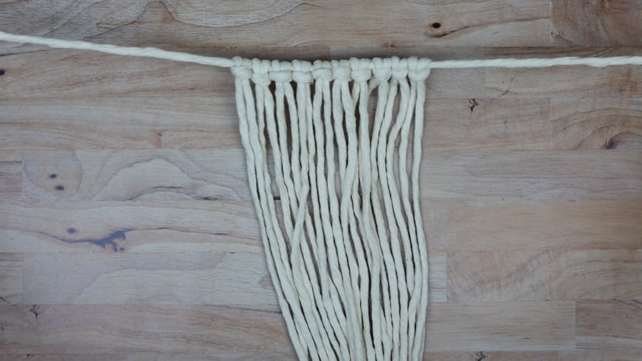 attaching the working cords to the holding cord using lark's head knots for macrame lamp shade