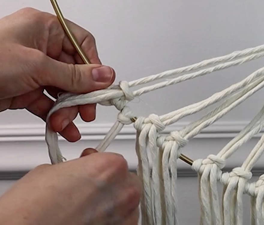 tying fringe to the bottom of macrame tree of life