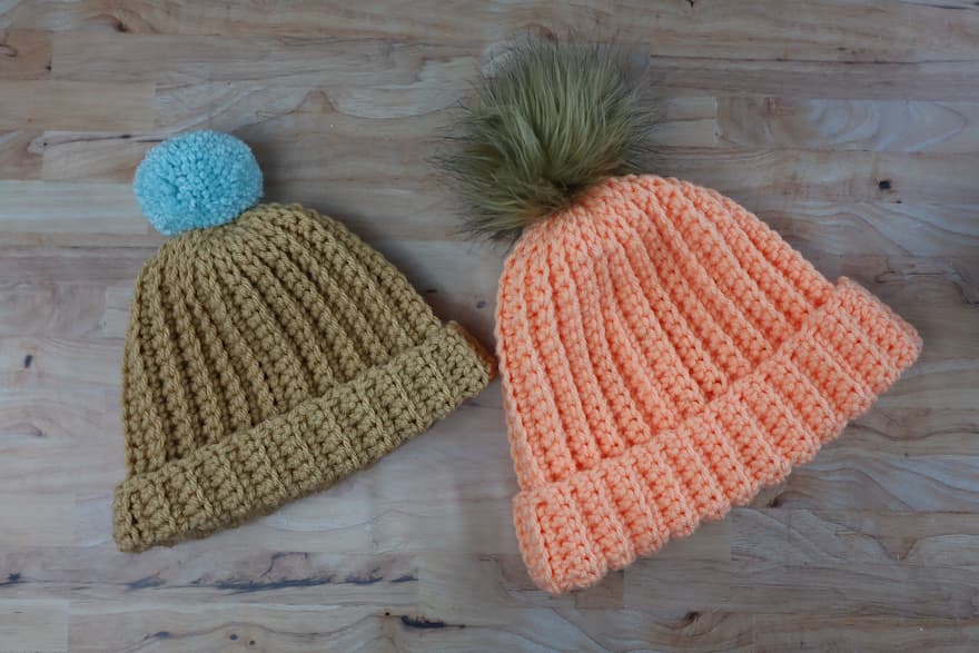 two finished ribbed beanie hats in different sizes
