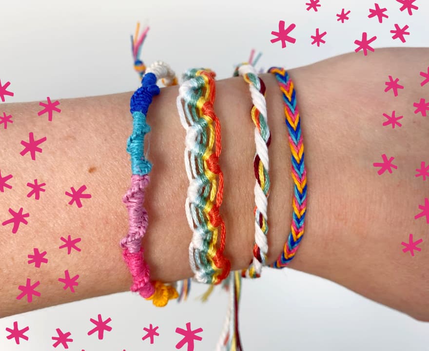 four colorful finished friendship bracelets on my wrist