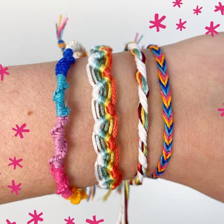 four colorful finished friendship bracelets on my wrist
