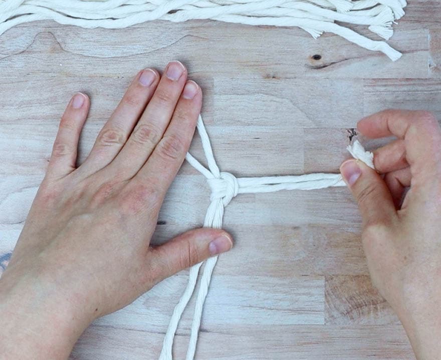 tie a larks head knot with the first piece of cord for the macrame feather