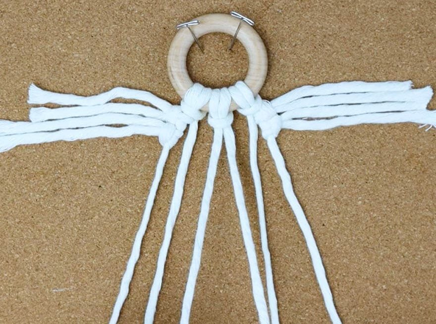 attach short pieces of cord to the right and left side