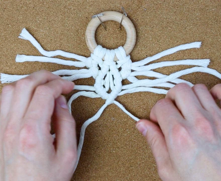 connect the two sides with one last double half hitch knot going down and to the left