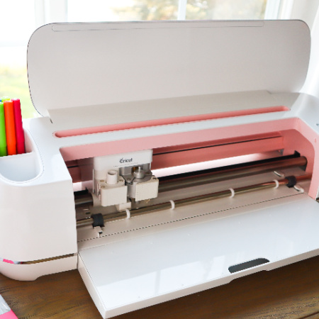 Picture of an opened up rose gold Cricut Maker