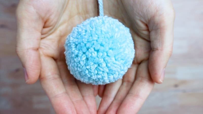 adorable and perfect blue yarn pom pom