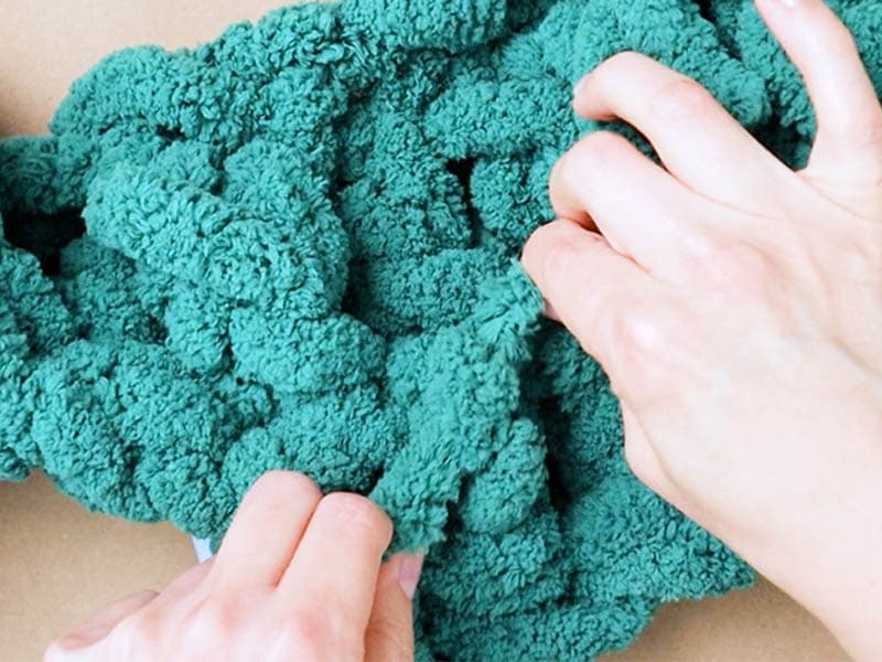 after you crochet a few stitches, go back and tie the ends of the yarn together to secure