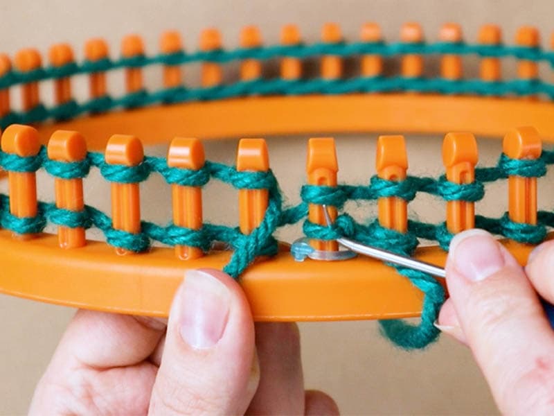 hooking the stitch on the knitting loom