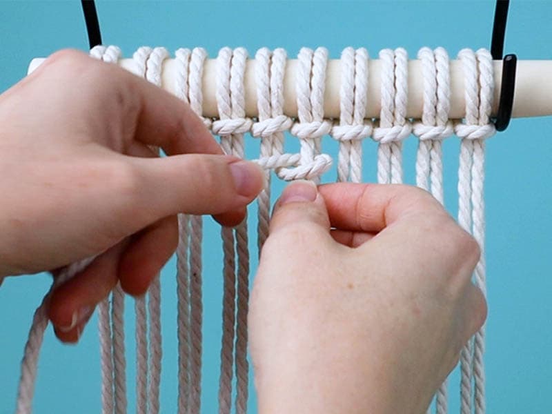 make a half hitch knot around the center right cord with the center left cord