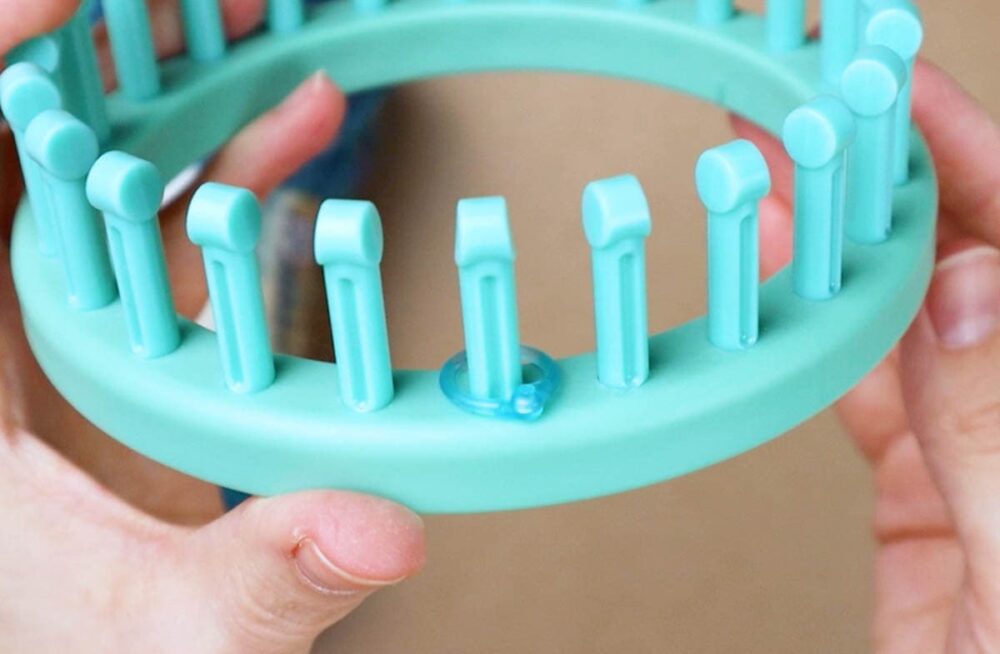 sock knitting loom with a stitch marker on the first peg