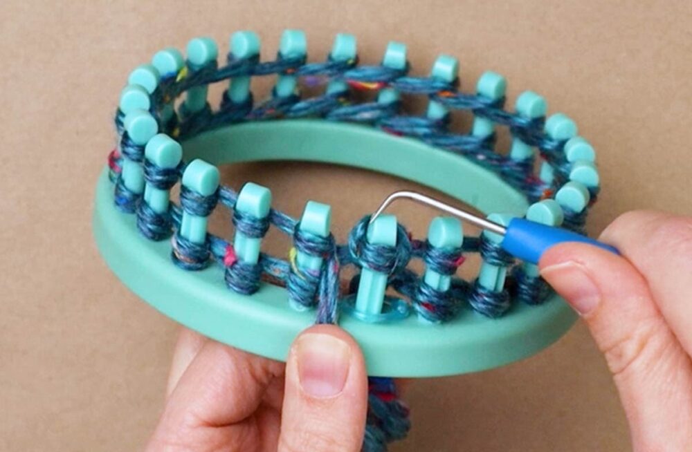 pull the bottom loop off of the peg