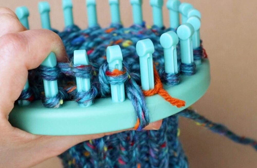 knit both loops off of peg 11 as one