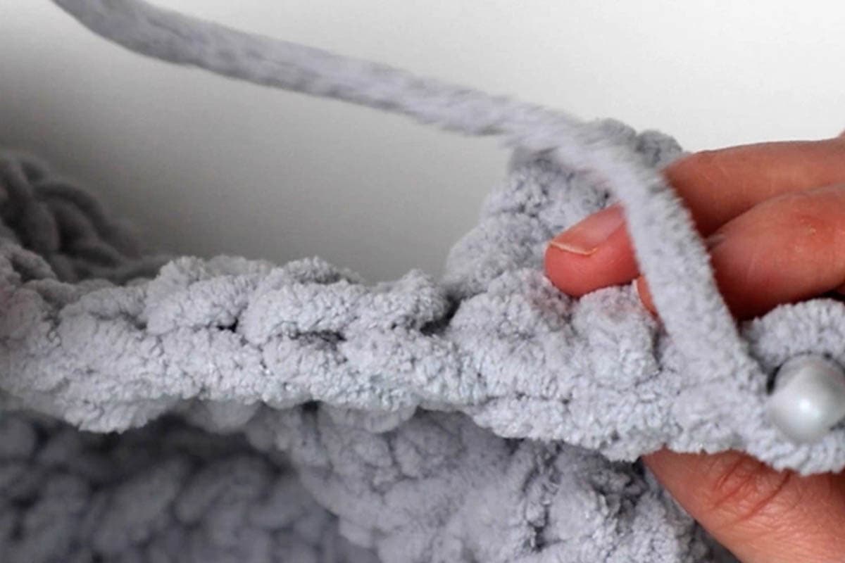make 2 double crochet under the top two loops of each stitch in the last row