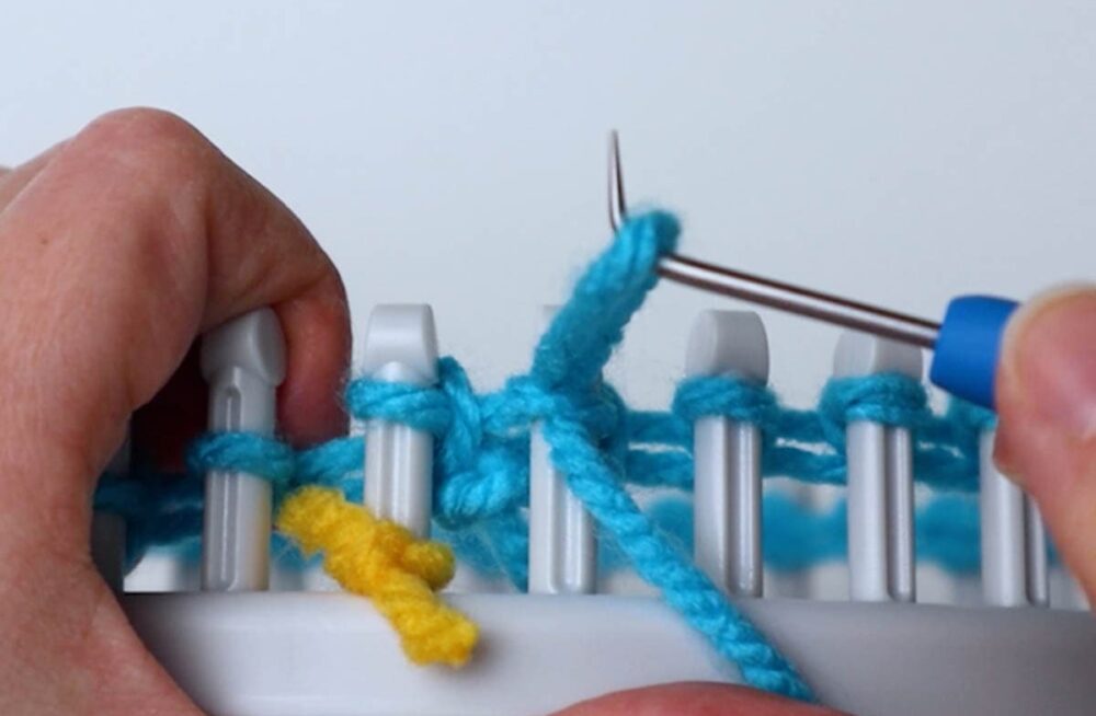 insert the hook into the top of the loop and hook the working yarn, pulling up a loop