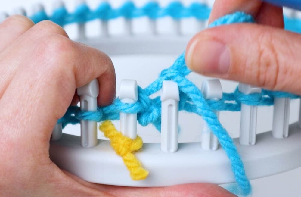 pull the original loop off the peg, holding the new loop