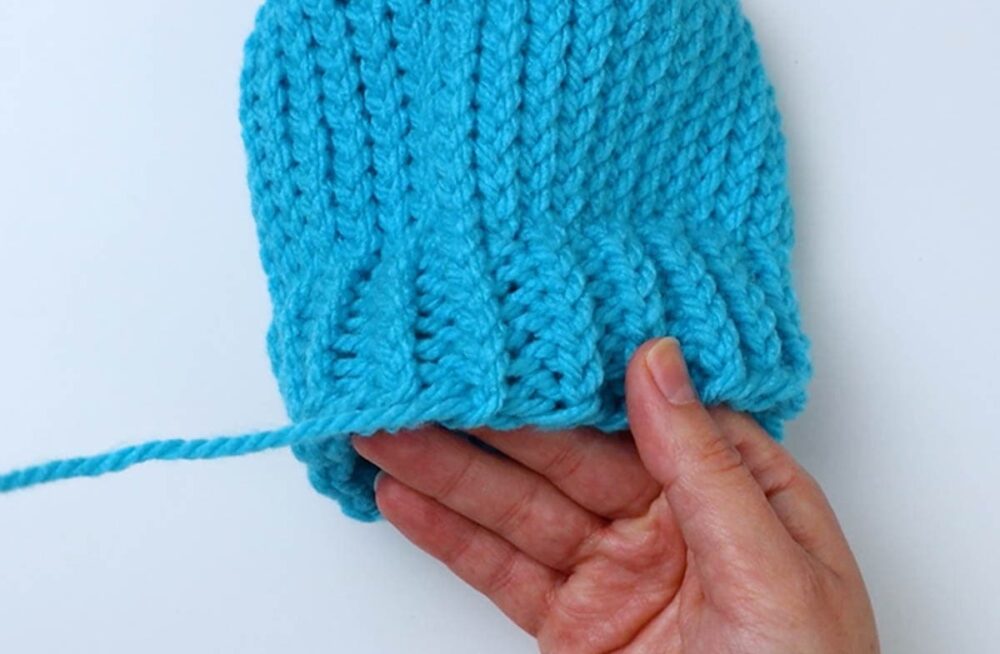 untie the slip knot and pull the end of the yarn to remove the excess slack