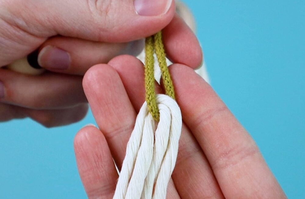 Use a small piece of thinner cord to make threading on the bead easier