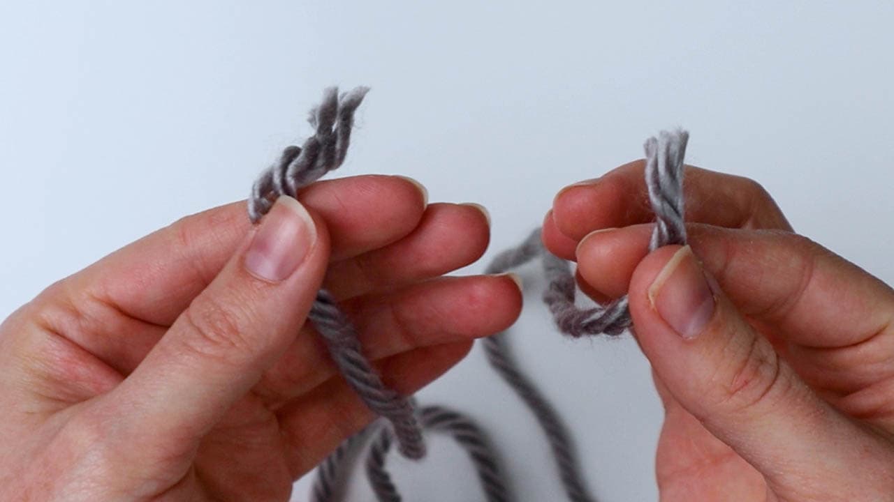 hold the two ends of yarn together