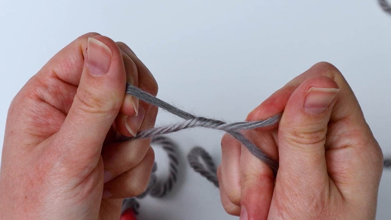 tie a knot to attach the yarn