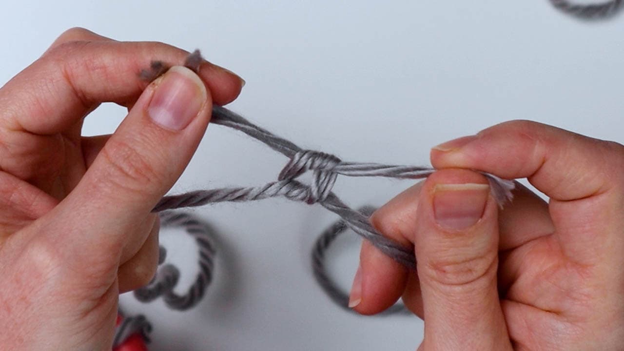 tie a knot to attach the yarn