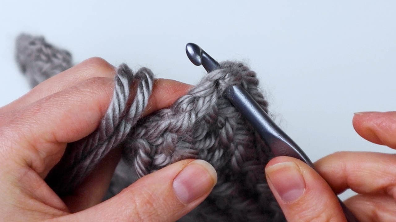 insert hook into the corner of the scarf