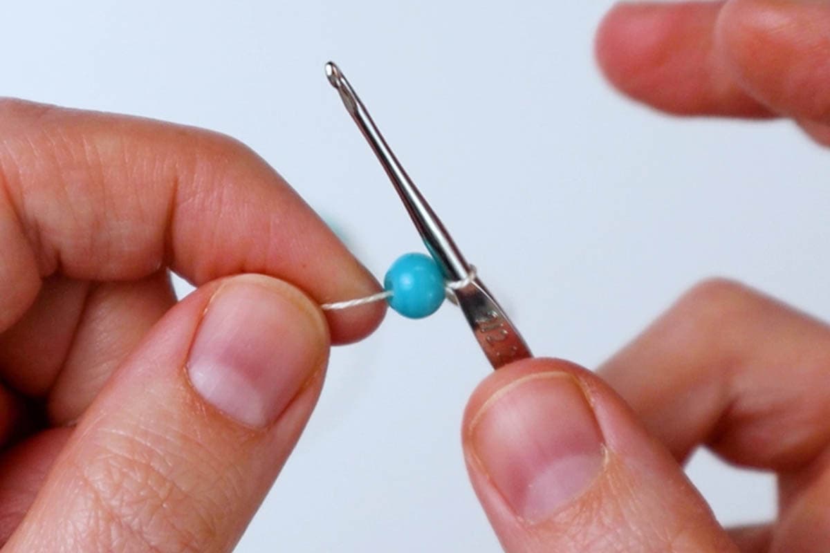 make the first chain stitch and slide the first bead up