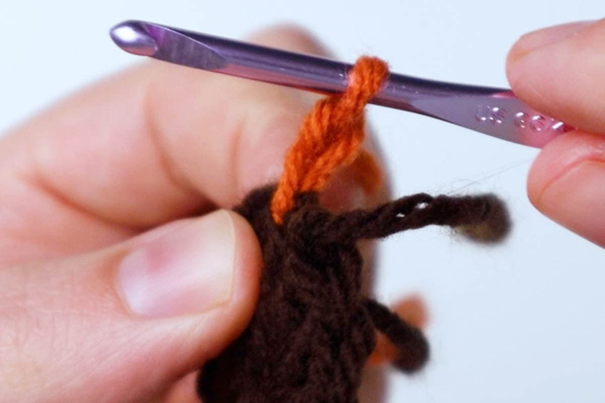 orange yarn attached to first round