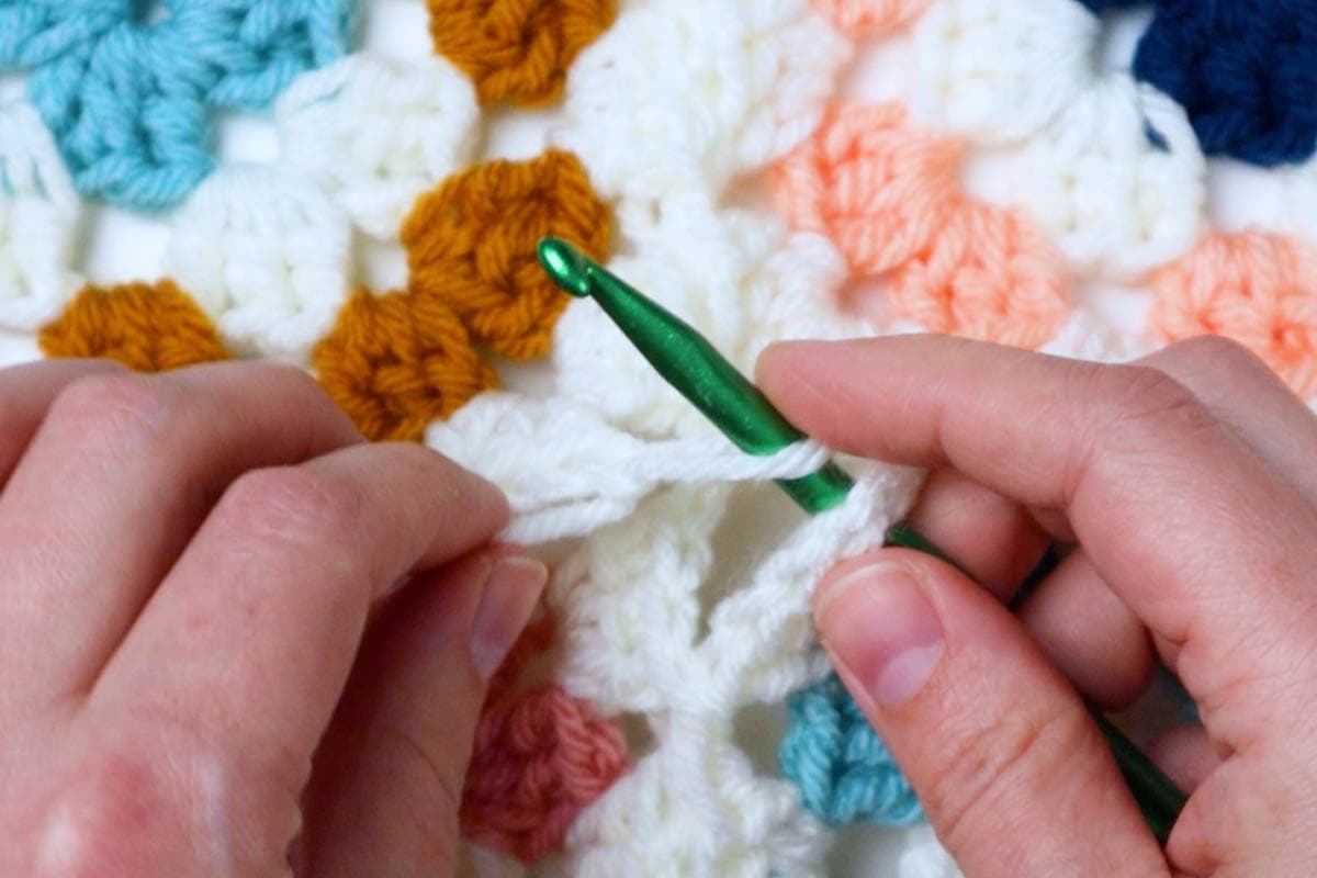 insert into the loose corner space and place the loop back on the hook