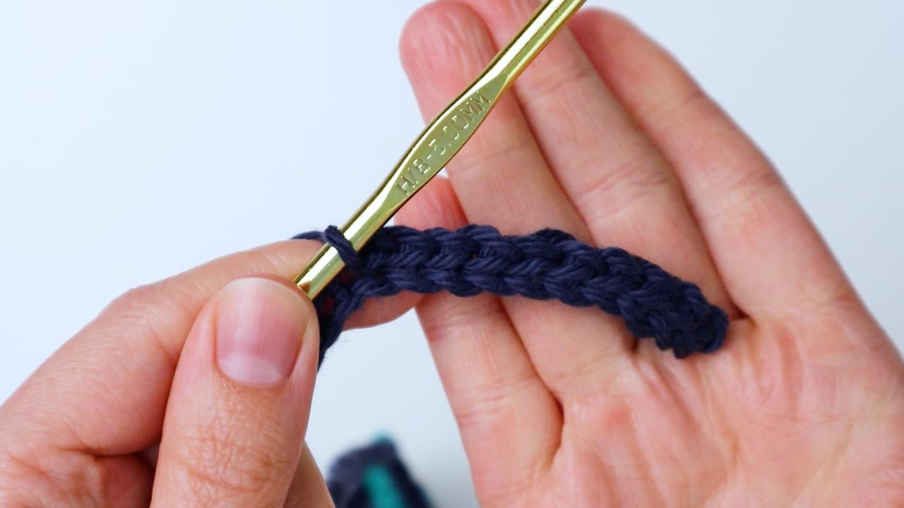 making the first strap of the bandana