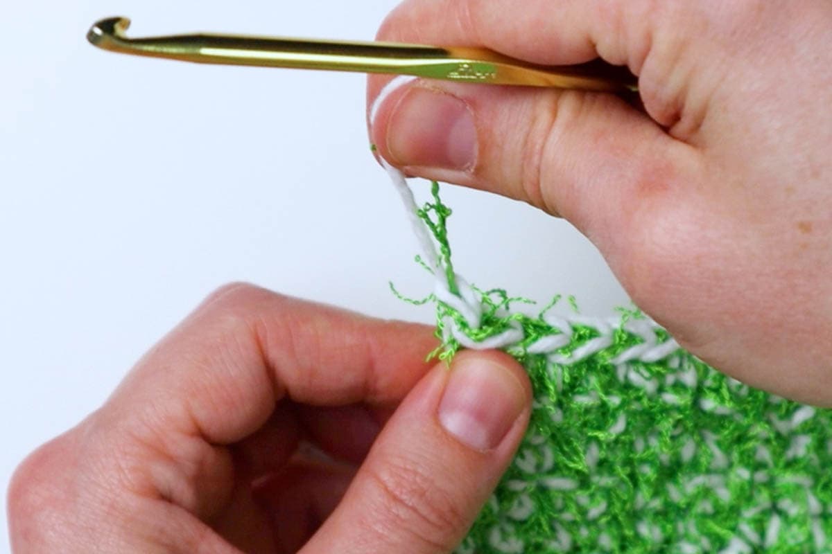 pull the cut end of the yarn through the loop and pull to tighten