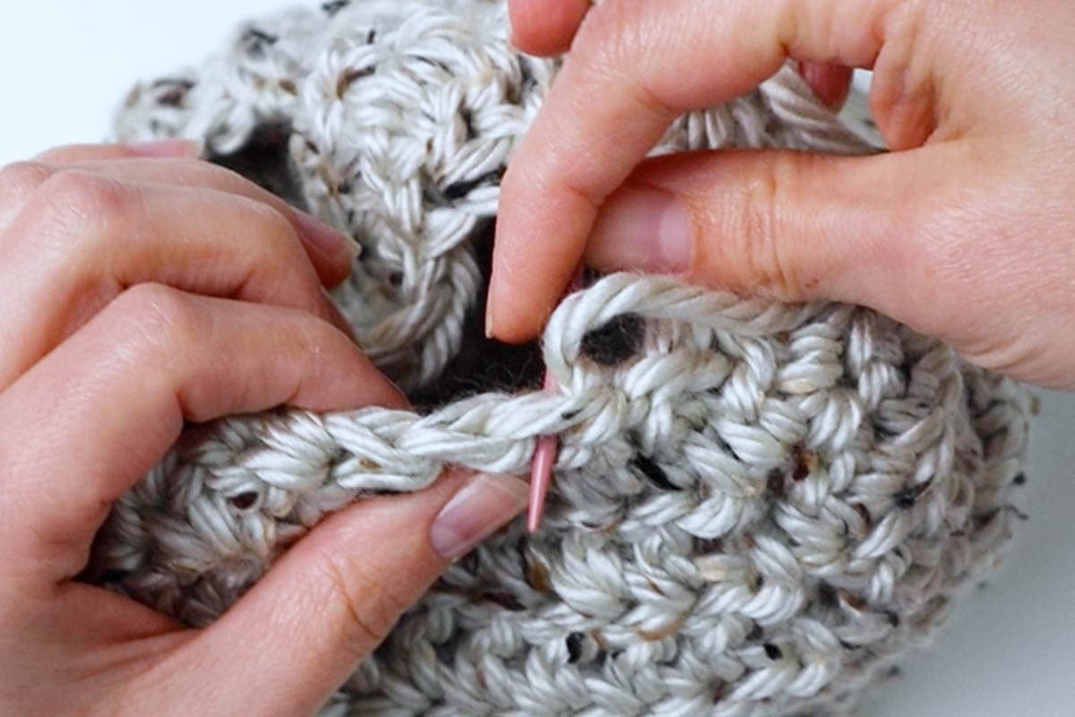 sew a running stitch to cinch up the hat hole