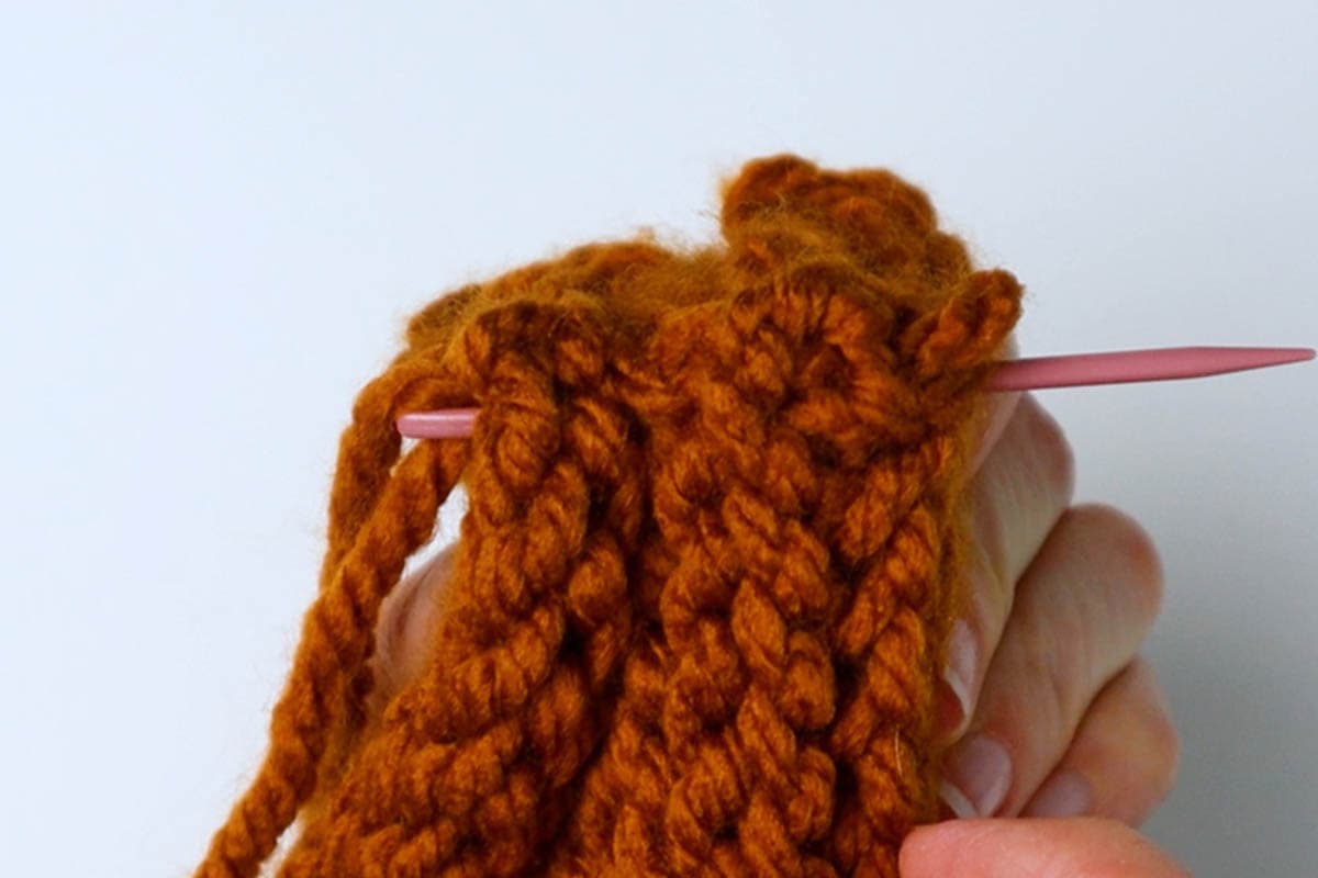 sew through all the layers to secure the twisted part of the headband