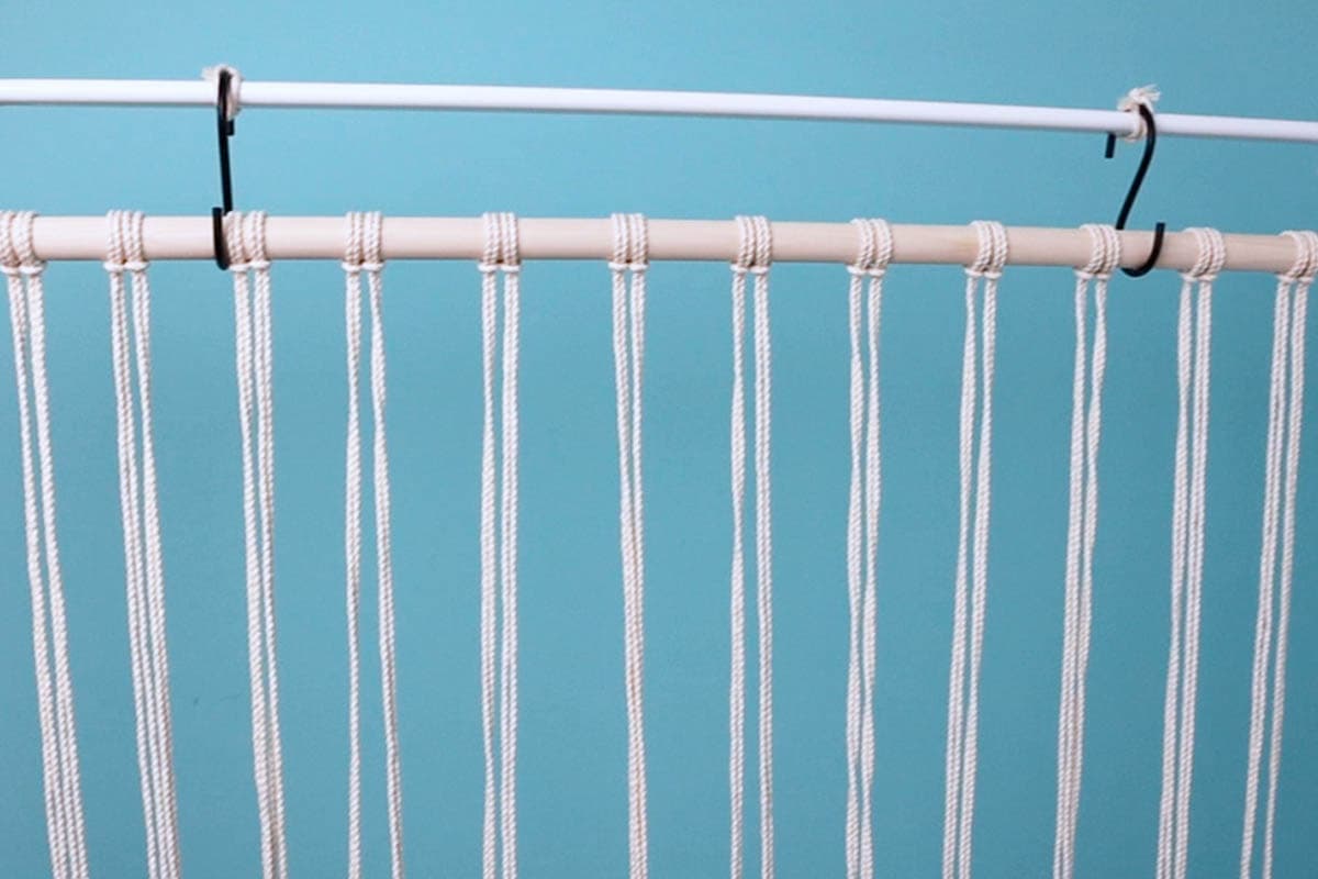 all cords attached to the dowel with lark's head knots
