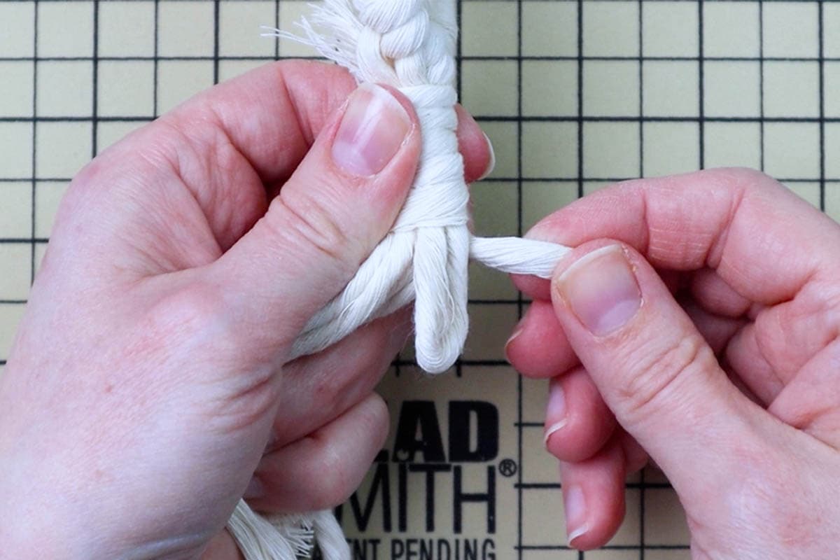 tying the wrapping knot at the bottom of the macrame keychain