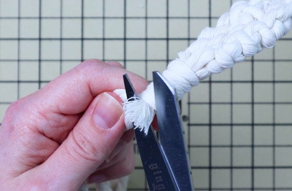 trimming off the excess cord from the wrapping knot