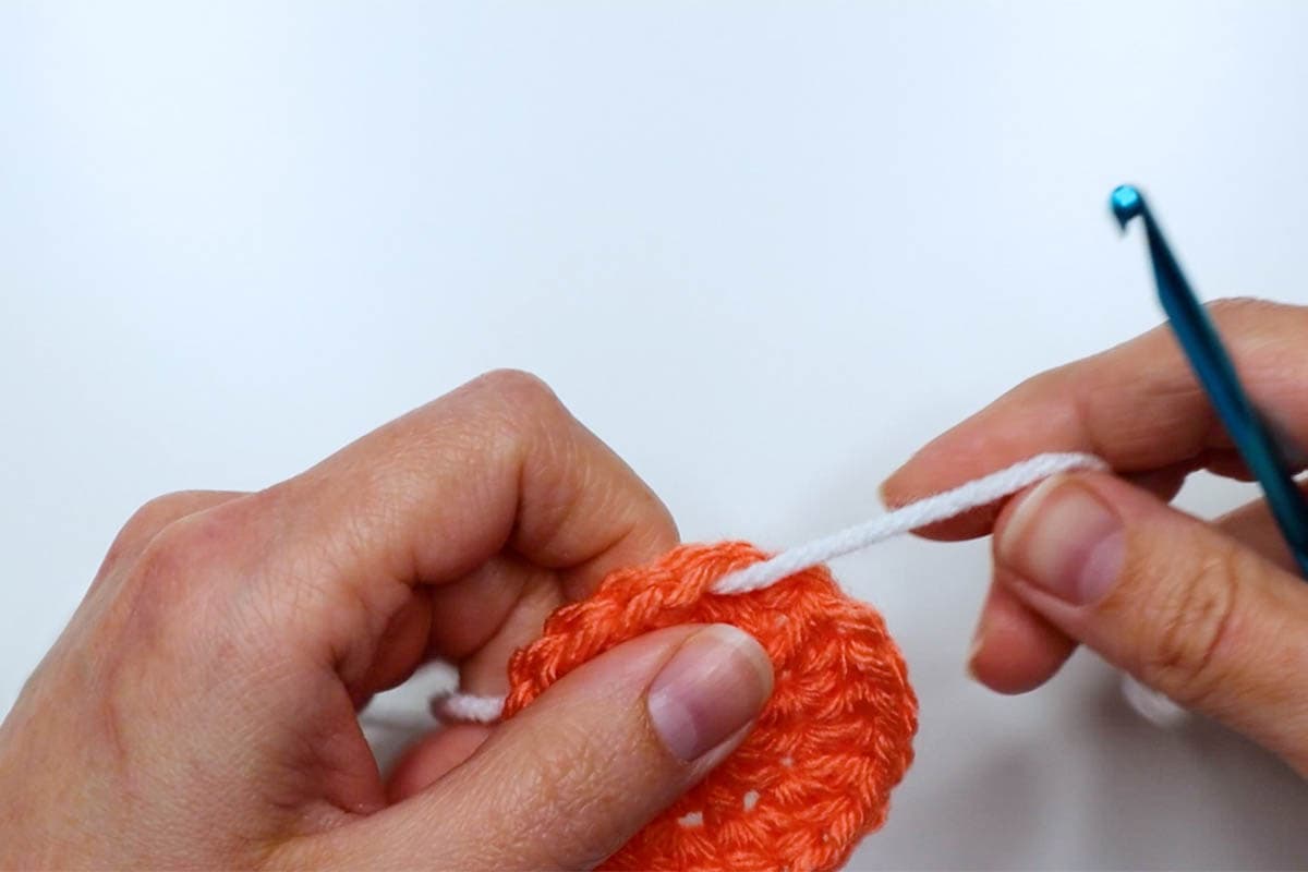 thread new yarn through one of the stitches