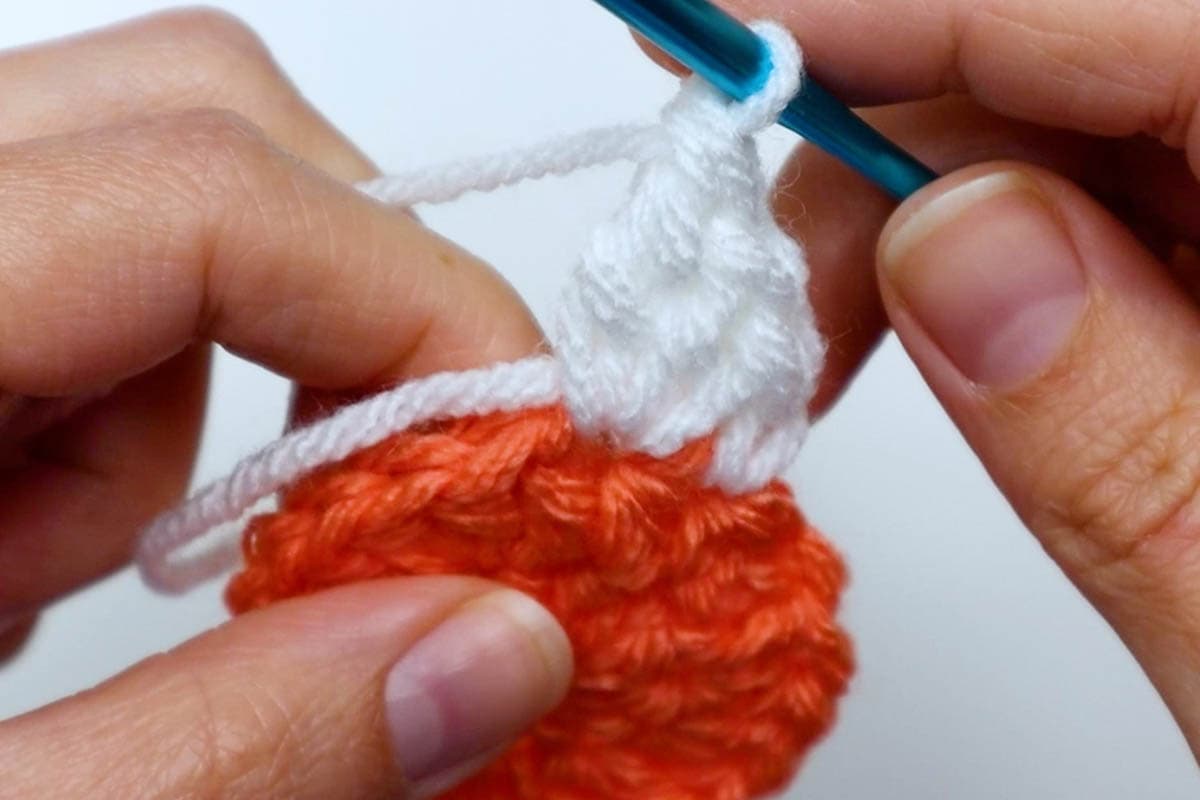 2 double crochets and one treble crochet worked in the next stitch