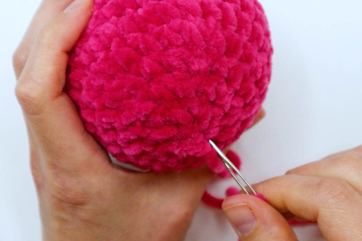 insert the needle into the bottom of the ball