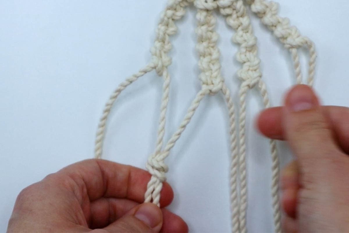 tying the first row of overhand knots