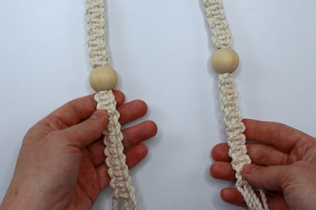 two finished square knot and bead sections an the arms