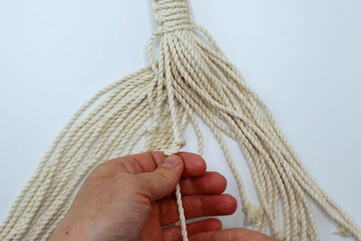 tying overhand knots in cord ends
