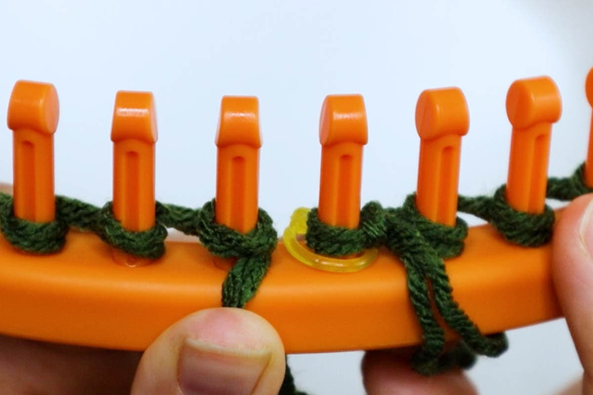 push the loops to the bottom of the pegs
