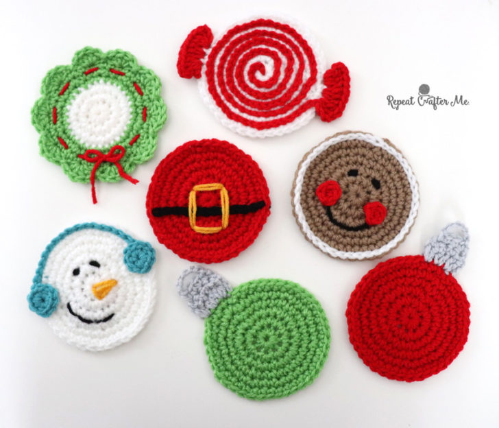 several crochet holiday coasters all laying next to each other