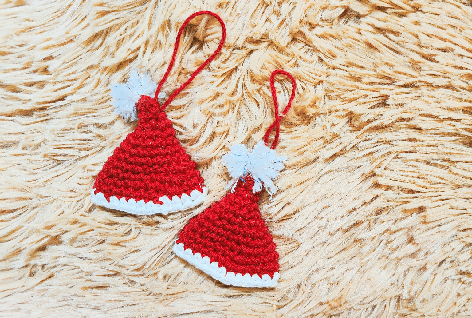 two red and white crochet Santa hat ornaments
