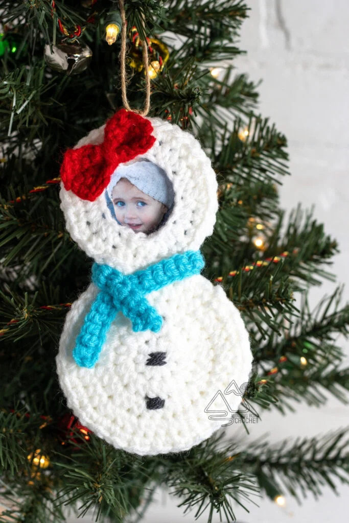 Crochet snowman ornament with photo holder where the face goes