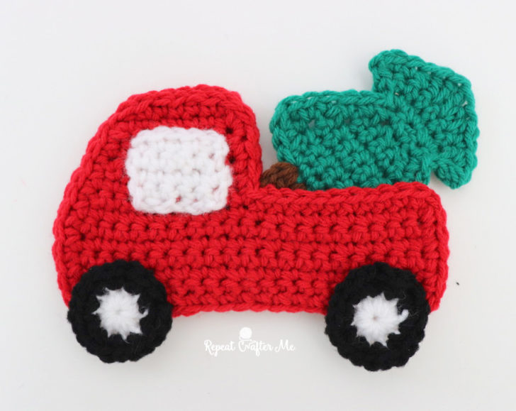 Crochet red truck ornament with tree in the back