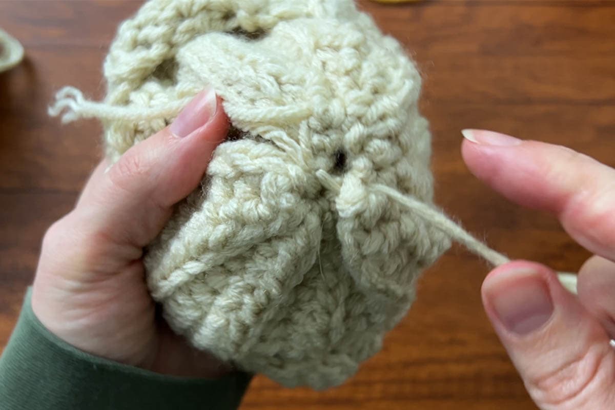 sewing a cross to hold the bottom hole together