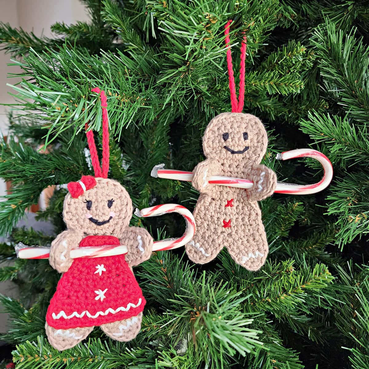 two crochet gingerbread man candy cane holder ornaments